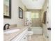 Traditional bathroom with a vanity, granite countertop, tub with a shower and a view out the window at 3925 Rock Mill Pkwy, Marietta, GA 30062