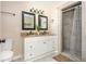 Bathroom with double sink vanity, granite countertops, and tile surround shower at 3925 Rock Mill Pkwy, Marietta, GA 30062
