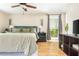 Spacious main bedroom with a ceiling fan, hardwood floors, and an expansive window at 3925 Rock Mill Pkwy, Marietta, GA 30062
