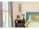 Bedroom with hardwood floors featuring a nightstand, lamp, and neutral-toned walls at 3925 Rock Mill Pkwy, Marietta, GA 30062