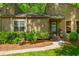 Close-up exterior view of a home entrance featuring a front yard with well-maintained shrubbery at 3925 Rock Mill Pkwy, Marietta, GA 30062