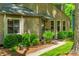 Close-up exterior view of a home featuring a sidewalk, manicured shrubbery, and blossoming flowers at 3925 Rock Mill Pkwy, Marietta, GA 30062