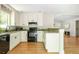 Updated kitchen with white cabinets, granite countertops, and stainless steel appliances at 3925 Rock Mill Pkwy, Marietta, GA 30062