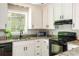 Updated kitchen featuring white cabinets, granite countertops, and modern appliances at 3925 Rock Mill Pkwy, Marietta, GA 30062