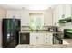 Bright kitchen with white cabinets, stainless steel appliances, granite countertops and hardwood floors at 3925 Rock Mill Pkwy, Marietta, GA 30062