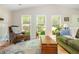 Bright living room with a vaulted ceiling, hardwood floors, and large windows overlooking the backyard at 3925 Rock Mill Pkwy, Marietta, GA 30062