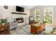 Inviting living room showcasing a stone fireplace, hardwood floors, and a comfortable seating arrangement at 3925 Rock Mill Pkwy, Marietta, GA 30062