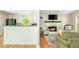Open concept living room and kitchen area with hardwood floors and a fireplace at 3925 Rock Mill Pkwy, Marietta, GA 30062