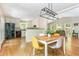 Open concept living and dining area with hardwood floors, modern lighting, and a view of the kitchen at 3925 Rock Mill Pkwy, Marietta, GA 30062
