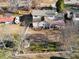 Aerial view of home showing expansive backyard, mature trees, landscaping, and decorative white fencing at 317 Ellenwood Dr, Bowdon, GA 30108