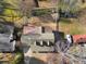 Aerial view of the property showcasing the house, surrounding yard, mature trees, driveway, and proximity to other residences at 317 Ellenwood Dr, Bowdon, GA 30108