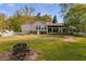 The extensive backyard is a lush oasis featuring well-kept lawns and a border of mature shade trees at 317 Ellenwood Dr, Bowdon, GA 30108