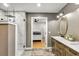 Bathroom featuring a double sink vanity, a standing shower, and entry view to the bedroom at 317 Ellenwood Dr, Bowdon, GA 30108
