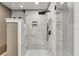 Shower featuring white tile, a glass door, and a black shower head with fixtures at 317 Ellenwood Dr, Bowdon, GA 30108