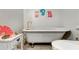 Bright bathroom featuring a vintage clawfoot tub with gold fixtures at 317 Ellenwood Dr, Bowdon, GA 30108