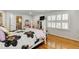 Bright bedroom featuring hardwood floors, a closet and a view into the bathroom at 317 Ellenwood Dr, Bowdon, GA 30108
