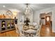 Elegant dining room with a round table and decorative cabinet at 317 Ellenwood Dr, Bowdon, GA 30108