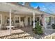 Inviting front porch featuring brick flooring, a ceiling fan, rocking chairs, and a decorative welcome sign at 317 Ellenwood Dr, Bowdon, GA 30108