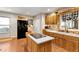 Charming kitchen with wooden cabinets, brick backsplash, and center island at 317 Ellenwood Dr, Bowdon, GA 30108