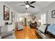 Spacious living room with hardwood floors, neutral walls, and an array of comfortable seating options at 317 Ellenwood Dr, Bowdon, GA 30108