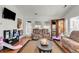 Comfortable living room is equipped with a TV, reclining sofa, and patio access at 317 Ellenwood Dr, Bowdon, GA 30108