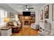 Stylish living room showcasing a fireplace, built-in bookshelves, and comfortable seating arrangement at 317 Ellenwood Dr, Bowdon, GA 30108