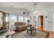 Inviting living room with vaulted ceilings and abundant natural light from windows overlooking the backyard at 317 Ellenwood Dr, Bowdon, GA 30108