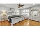 Spacious bedroom boasts hardwood floors, a ceiling fan, and ample natural light at 317 Ellenwood Dr, Bowdon, GA 30108