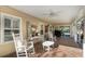 Relaxing covered porch with brick flooring, ceiling fan, and comfortable seating area at 317 Ellenwood Dr, Bowdon, GA 30108