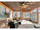 Enclosed sunroom features stone floors and lots of natural light streaming through the windows with lovely outdoor views at 317 Ellenwood Dr, Bowdon, GA 30108