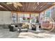 This sunroom boasts stone floors, ample seating, a unique hanging chair, and is filled with natural light at 317 Ellenwood Dr, Bowdon, GA 30108