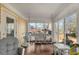 Cozy sunroom with brick floors, large windows, and a charming swing for relaxation at 317 Ellenwood Dr, Bowdon, GA 30108
