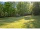 Expansive backyard with lush greenery, mature trees, and ample space for outdoor activities and relaxation at 3833 Coral Ln, Douglasville, GA 30135