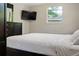The bedroom features a queen bed, dark furniture, a TV, and a lovely view of the outdoors at 3833 Coral Ln, Douglasville, GA 30135
