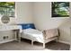 Bright bedroom with a single bed, a makeup table, and a black trimmed window at 3833 Coral Ln, Douglasville, GA 30135