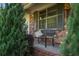 Cozy front porch with a bench, surrounded by lush greenery and brick accents at 3833 Coral Ln, Douglasville, GA 30135