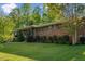 Beautiful front yard of this brick home with mature trees and manicured landscaping at 3833 Coral Ln, Douglasville, GA 30135