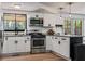Updated kitchen with stainless steel appliances and an adjacent sunroom with natural light at 3833 Coral Ln, Douglasville, GA 30135