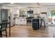 Bright kitchen featuring stainless steel appliances, white cabinetry, and wood floors at 3833 Coral Ln, Douglasville, GA 30135