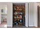 Organized pantry featuring brick accent wall with stocked shelves, storage solutions, and easy access at 3833 Coral Ln, Douglasville, GA 30135