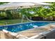Relaxing backyard pool area complete with outdoor seating, umbrella for shade, and a fun water slide at 3833 Coral Ln, Douglasville, GA 30135