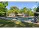Backyard pool with slide, ladders and spacious deck plus home's sunroom and outdoor cooking area, ideal for summer entertaining at 3833 Coral Ln, Douglasville, GA 30135