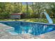 Refreshing in-ground pool features a slide, ladders, spacious deck, and convenient access to backyard storage shed at 3833 Coral Ln, Douglasville, GA 30135
