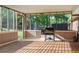 Relaxing screened porch with wooden floors, paint cans, and an outdoor cooking area at 3833 Coral Ln, Douglasville, GA 30135