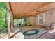 Covered back patio with stone floor, perfect for outdoor entertaining, featuring chairs and a rug at 3990 Admiral Dr, Chamblee, GA 30341