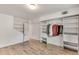 Bedroom featuring built-in wardrobe, laminate flooring and view of door at 3990 Admiral Dr, Chamblee, GA 30341