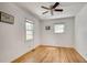 Bright bedroom with hardwood floors, two windows, and a ceiling fan at 3990 Admiral Dr, Chamblee, GA 30341