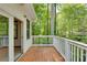 Cozy deck with white railing overlooks a lush green wooded area at 3990 Admiral Dr, Chamblee, GA 30341