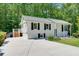 View of the side of the house showcasing the concrete driveway and steps to a back deck at 3990 Admiral Dr, Chamblee, GA 30341