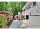 Home exterior with a staircase leading to the back door and surrounded by landscaping at 3990 Admiral Dr, Chamblee, GA 30341